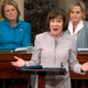 Sen. Cindy Hyde-Smith sits to the right.
